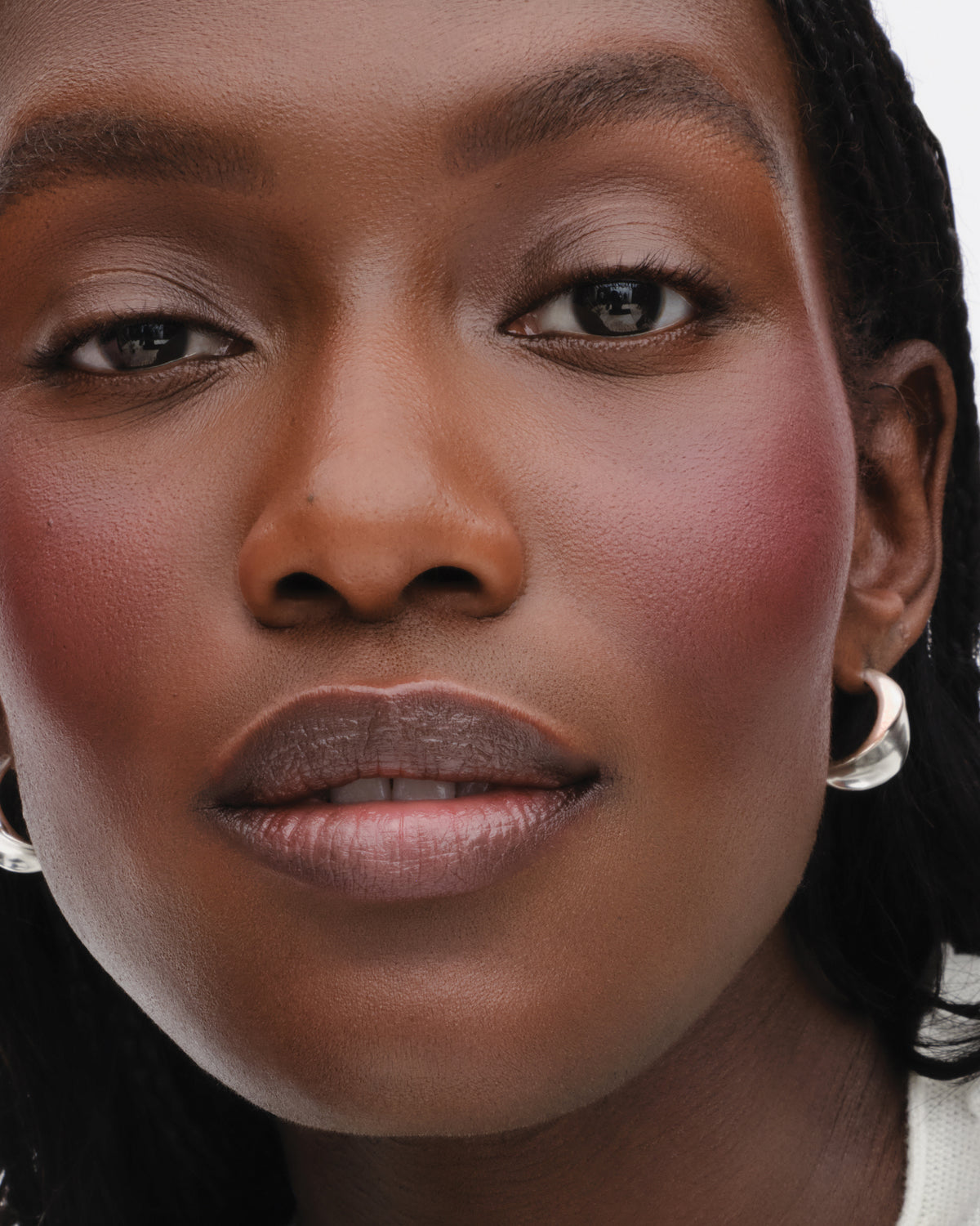 Model wears the Baby Cheeks Powder Blush Duo in Jam/Fizz. 