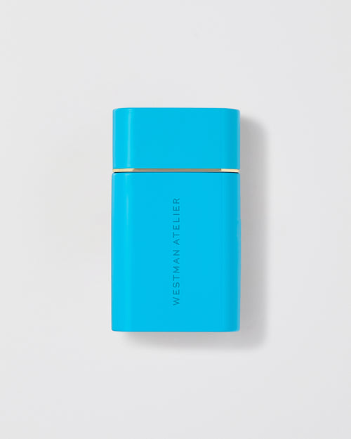 Sun Tone Bronzing Drops in a light blue bottle.