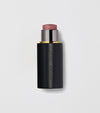 Black makeup stick with pink top on a light gray background.