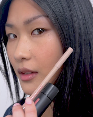 Model applies lip liner in Biscuit.