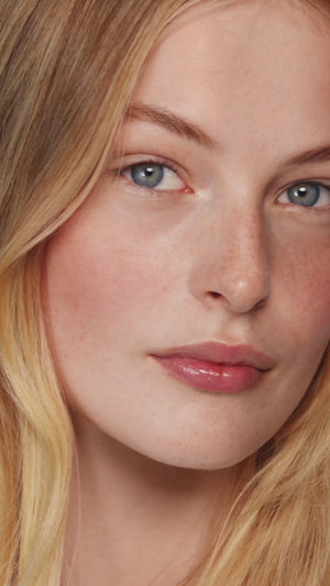 Makeup artist applies the Powder Duo in Petal / Biscuit on blonde model. 